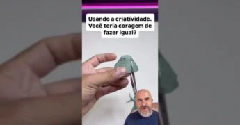 Imagem detalhada de um diorama verde com árvores de caixa de ovos, rio azul e casinhas de papelão, criação de Canal Dicas Inteligentes.